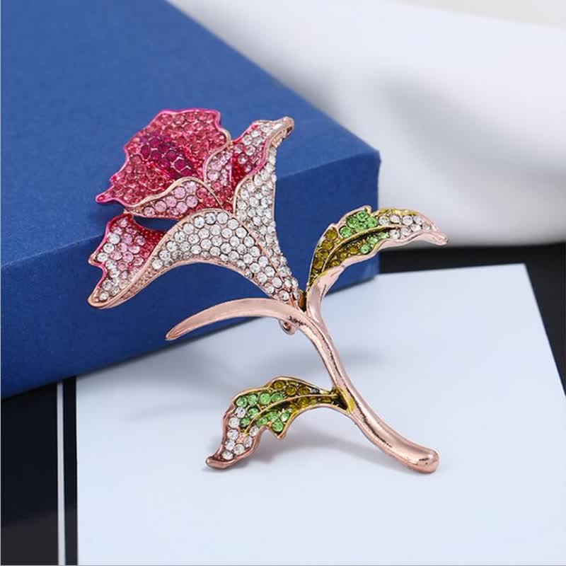 Graziosa spilla con fiore di orchidea e strass