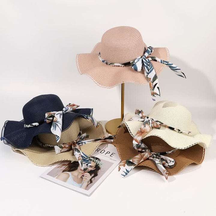 Cappello di paglia pieghevole con decorazione di perle e nastri floreali estivi da donna