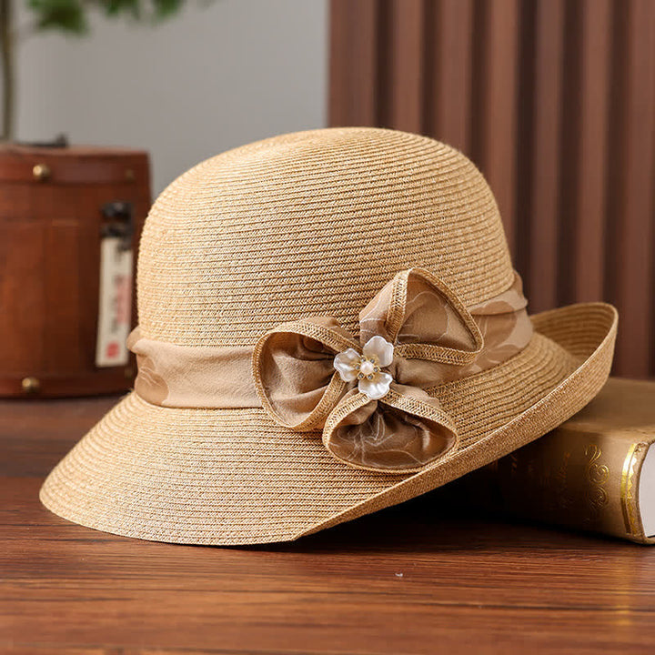 Cappello da donna in paglia con decorazione a margherita e nastro floreale