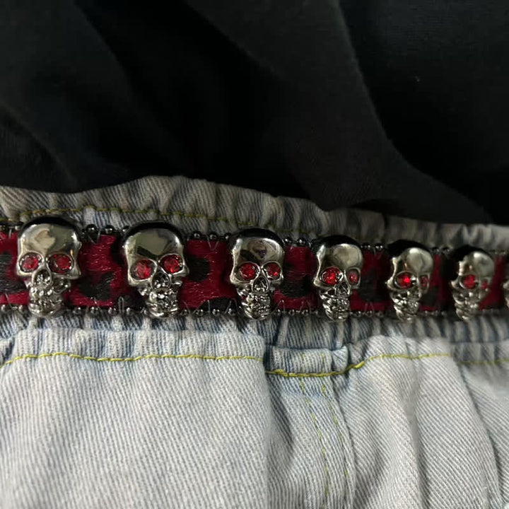 Cintura in pelle con stampa leopardata e rivetti a forma di teschio gotico