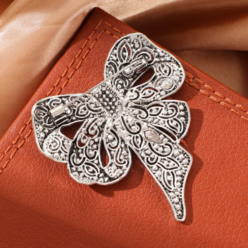 Spilla da donna in argento antico a forma di fiocco con strass