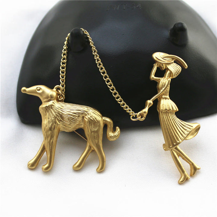 Spilla a catena in oro con dama e cane - image 0