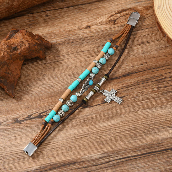 Bracciale in pelle a strati con piume turchesi e croce - image 2