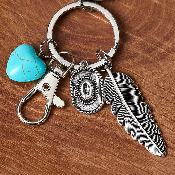 Portachiavi con coltello pieghevole in argento e ciondolo a forma di piuma western turchese. - image 3