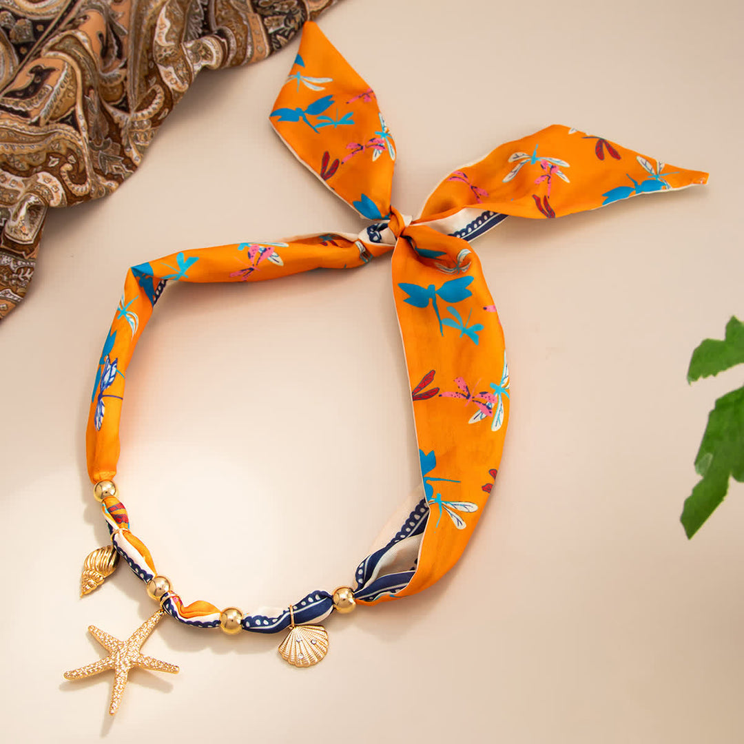 Collana con ciondolo a forma di stella marina arancione, conchiglia e libellula. - image 1