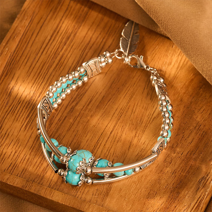 Bracciale vintage boho a triplo strato con piume turchesi e argento anticato - image 2