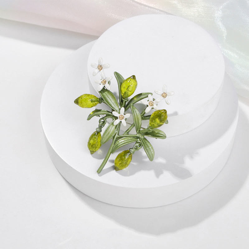 Spilla da donna a forma di goccia di limone con pianta verde