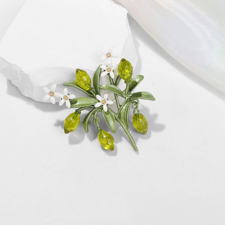 Spilla da donna a forma di goccia di limone con pianta verde