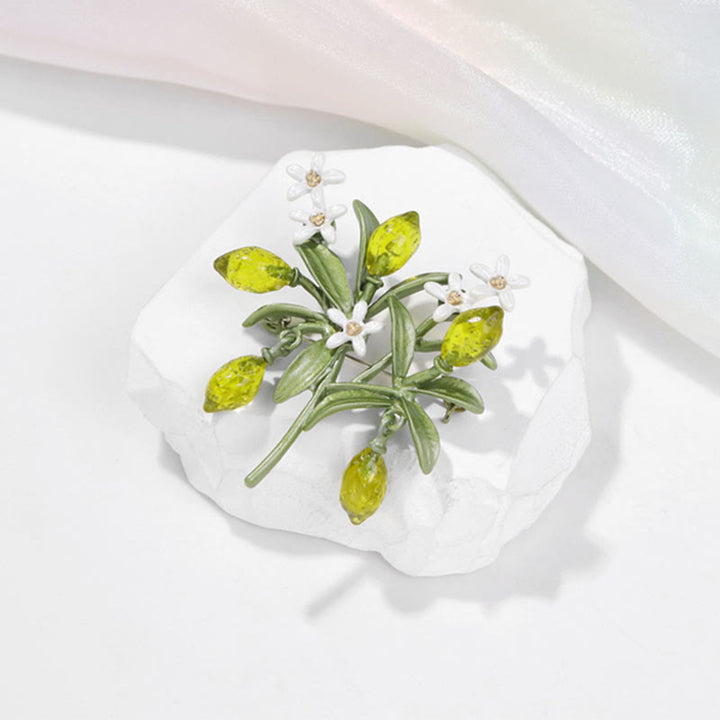 Spilla da donna a forma di goccia di limone con pianta verde